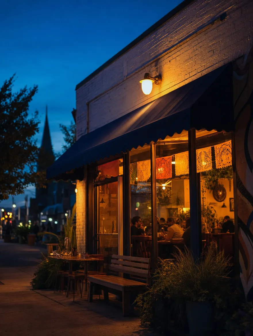 A small taqueria glowing at dusk